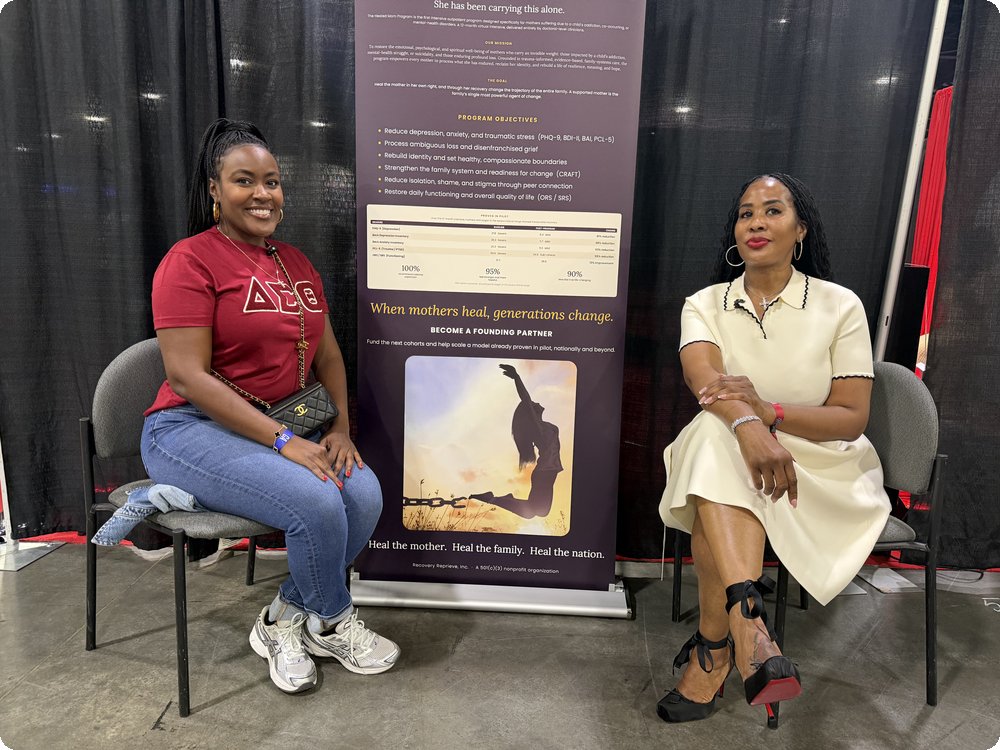 Dr. Scherri Culp at InvestFest, seated beside The Healed Mom program banner
